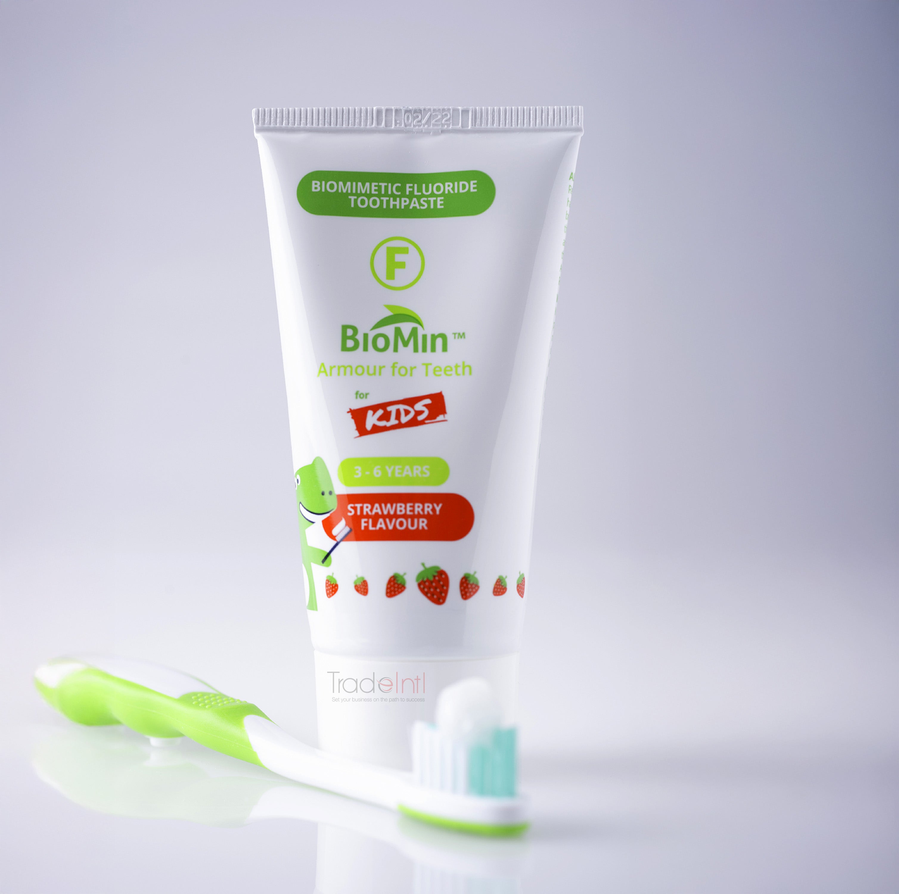 BioMin Kids toothpaste tube with a green toothbrush on a light gray background